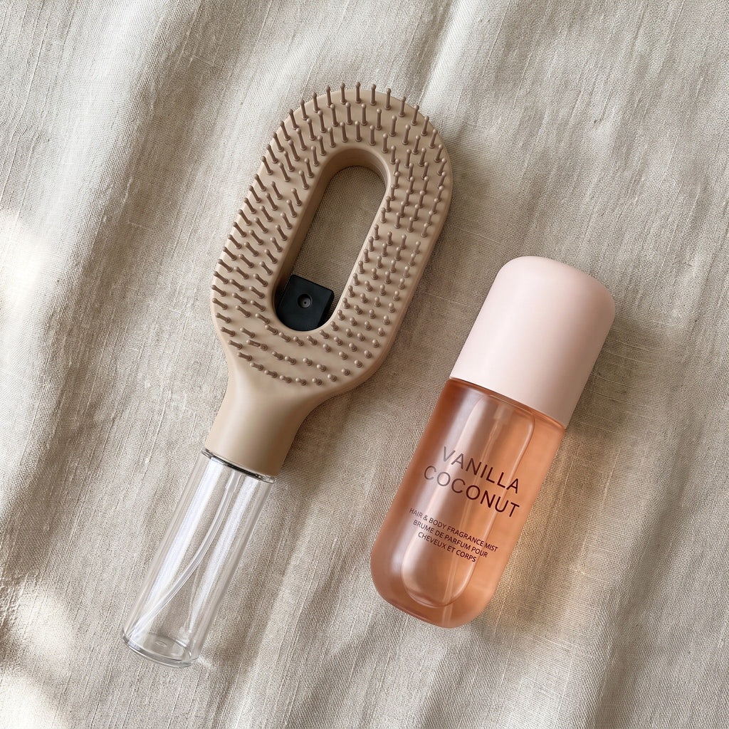 Brumelle Vanilla Coconut Scent Mist laid on linen beside the Brumelle Hydrating Brush in beige