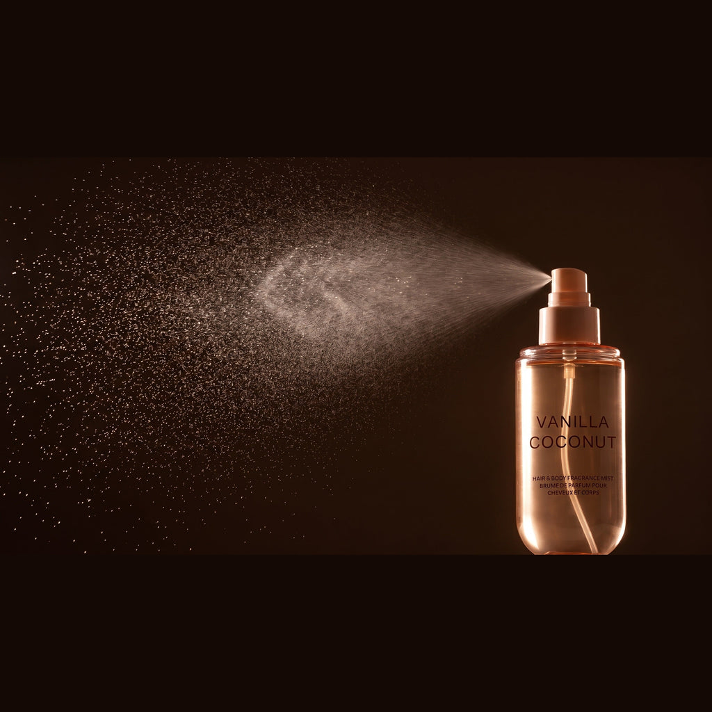 The Vanilla Coconut Scent Mist from the Complete Ritual Set releasing a fine spray, close-up on a dark background