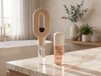 The Brumelle Hydrating Brush and Hydrating Scent Mist together on a bathroom counter